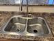 A stainless steel double sink with modern faucet under a granite countertop at 4117 W Allen St, Laveen, AZ 85339