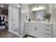 Bright bathroom showcasing a vanity with white cabinets, quartz countertop, and glass-enclosed walk-in shower at 475 N 9Th St # 303, Phoenix, AZ 85006