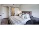 This modern bedroom features a wooden headboard, stylish sliding door, and cozy bedding at 475 N 9Th St # 303, Phoenix, AZ 85006