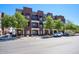 Multi-story building with red brick and small balconies with mature trees in front at 475 N 9Th St # 303, Phoenix, AZ 85006