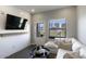 Cozy living room with a white sofa, modern decor, and a mounted TV at 475 N 9Th St # 303, Phoenix, AZ 85006