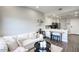 Bright living room with a white sectional sofa and a modern, open-concept kitchen at 475 N 9Th St # 303, Phoenix, AZ 85006