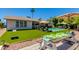 Backyard pool surrounded by well-maintained artificial turf and outdoor dining area at 4932 E Kathleen Rd, Scottsdale, AZ 85254