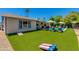 Backyard pool with lounge seating, green turf, and cornhole boards at 4932 E Kathleen Rd, Scottsdale, AZ 85254