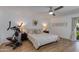Bright bedroom with exercise equipment, neutral decor, and sliding door to backyard at 4932 E Kathleen Rd, Scottsdale, AZ 85254