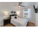 Comfortable bedroom features a large window, ceiling fan, and modern decor at 4932 E Kathleen Rd, Scottsdale, AZ 85254