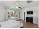 Bright bedroom with a ceiling fan, large window with backyard view, and a modern dresser with TV at 4932 E Kathleen Rd, Scottsdale, AZ 85254
