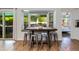 Breakfast nook features a built-in bench, a wooden table, and views of the outdoor kitchen and living space at 4932 E Kathleen Rd, Scottsdale, AZ 85254