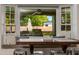 Cozy breakfast nook with cushioned seating and views of the outdoor kitchen and lush backyard at 4932 E Kathleen Rd, Scottsdale, AZ 85254