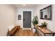 Entryway features a bench, console table with décor, mirror, and gray front door at 4932 E Kathleen Rd, Scottsdale, AZ 85254