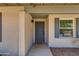 Covered front porch and front door with gray shutters and welcome mat at 4932 E Kathleen Rd, Scottsdale, AZ 85254