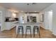 Stylish kitchen with white cabinetry, stainless steel appliances, a granite island, and sleek bar stool seating at 4932 E Kathleen Rd, Scottsdale, AZ 85254