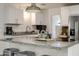 Close-up of the kitchen island featuring granite countertops, white cabinets, and stylish decor at 4932 E Kathleen Rd, Scottsdale, AZ 85254