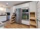 Modern kitchen with stainless appliances, pull-out shelves, white cabinetry, and granite countertops at 4932 E Kathleen Rd, Scottsdale, AZ 85254