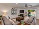 Cozy living room featuring a fireplace, ceiling fan, and glass doors to the pool at 4932 E Kathleen Rd, Scottsdale, AZ 85254