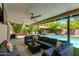 Inviting covered patio with comfortable seating, overlooking a sparkling pool and lush landscaping at 4932 E Kathleen Rd, Scottsdale, AZ 85254