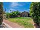 Well-maintained backyard with green lawn, patio, and desert landscaping offering outdoor living at 5952 E Phelps Rd, Scottsdale, AZ 85254