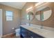 Bathroom with double sink vanity, granite countertops, tile flooring, and modern lighting at 5952 E Phelps Rd, Scottsdale, AZ 85254