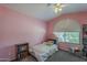 Charming pink bedroom with a cozy bed, bright window, and ample storage, perfect for a space at 5952 E Phelps Rd, Scottsdale, AZ 85254