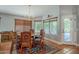 Bright dining room with round table, six chairs, area rug, and natural light from a window at 5952 E Phelps Rd, Scottsdale, AZ 85254