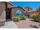 Close-up of a home showcasing an arched window, front door, and desert landscaping at 5952 E Phelps Rd, Scottsdale, AZ 85254