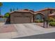 Inviting home features a two-car garage and low-maintenance landscaping at 5952 E Phelps Rd, Scottsdale, AZ 85254