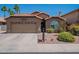 Attractive home featuring a spacious driveway and colorful, desert-friendly landscaping at 5952 E Phelps Rd, Scottsdale, AZ 85254