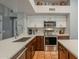 Modern kitchen with stainless steel appliances, an island, quartz countertops, and ample natural light at 5952 E Phelps Rd, Scottsdale, AZ 85254