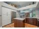 Kitchen with stainless steel appliances, wood cabinets, a kitchen island, and ample storage space at 5952 E Phelps Rd, Scottsdale, AZ 85254