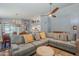 Spacious living area with terracotta floors, sectional sofa, and views into dining area at 5952 E Phelps Rd, Scottsdale, AZ 85254