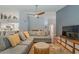 Comfortable living space featuring terracotta floors, sectional sofa, and open concept design at 5952 E Phelps Rd, Scottsdale, AZ 85254