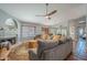 An open-concept living room and dining area with a ceiling fan and a cozy fireplace at 5952 E Phelps Rd, Scottsdale, AZ 85254