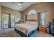 Cozy main bedroom features vaulted ceilings, carpet flooring, and access to the patio at 5952 E Phelps Rd, Scottsdale, AZ 85254