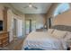 Comfortable main bedroom features vaulted ceilings, carpet flooring, and access to the patio at 5952 E Phelps Rd, Scottsdale, AZ 85254
