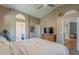 Light-filled main bedroom with ceiling fan, ensuite bathroom, walk-in closet, and TV at 5952 E Phelps Rd, Scottsdale, AZ 85254