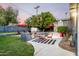 Outdoor kitchen with a built in grill and sparkling pool area in the backyard offers relaxation at 6746 E Monterosa St, Scottsdale, AZ 85251