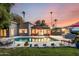 Backyard featuring a sparkling swimming pool, ample seating, and lush landscaping, perfect for relaxation and entertaining at 6746 E Monterosa St, Scottsdale, AZ 85251