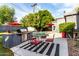Relaxing backyard featuring an outdoor kitchen with a stainless steel grill and sparkling swimming pool at 6746 E Monterosa St, Scottsdale, AZ 85251