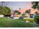 A spacious yard features a sparkling pool, outdoor seating, and a cozy ambiance at sunset at 6746 E Monterosa St, Scottsdale, AZ 85251