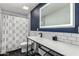Well-lit bathroom with black and white tiles, a walk in shower and an illuminated mirror above the sink at 6746 E Monterosa St, Scottsdale, AZ 85251
