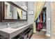 Contemporary bathroom with a double vanity, modern lighting, and a doorway to the walk-in closet at 6746 E Monterosa St, Scottsdale, AZ 85251