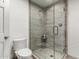 Modern bathroom featuring a glass enclosed shower with a stylish grey tile surround, toilet, and white walls at 6746 E Monterosa St, Scottsdale, AZ 85251
