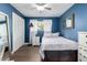 Cozy bedroom with blue walls, white trim, a ceiling fan, and a comfortable bed with fresh linens at 6746 E Monterosa St, Scottsdale, AZ 85251