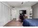 A bedroom with a ceiling fan, closet, television, desk, and laminate wood floors at 6746 E Monterosa St, Scottsdale, AZ 85251