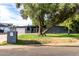 This modern home features a spacious driveway, xeriscaping, and a distinctive mailbox, enhancing its curb appeal at 6746 E Monterosa St, Scottsdale, AZ 85251