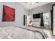 Cozy bedroom with a mounted TV, walk-in closet, ensuite bathroom, and soft, neutral tones at 6746 E Monterosa St, Scottsdale, AZ 85251
