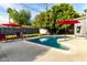 Backyard pool featuring lounge chairs, colorful plants, and outdoor dining area for relaxation at 6746 E Monterosa St, Scottsdale, AZ 85251