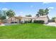 Expansive backyard with lush lawn, mature trees, covered patio, and ample space for recreation at 6819 N 10Th Pl, Phoenix, AZ 85014