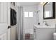 Bright bathroom featuring tiled shower with tub, window, framed mirror and white vanity with marble countertop at 6819 N 10Th Pl, Phoenix, AZ 85014