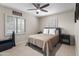 Bedroom with carpet, ceiling fan, a queen-sized bed, and matching nightstands at 6819 N 10Th Pl, Phoenix, AZ 85014